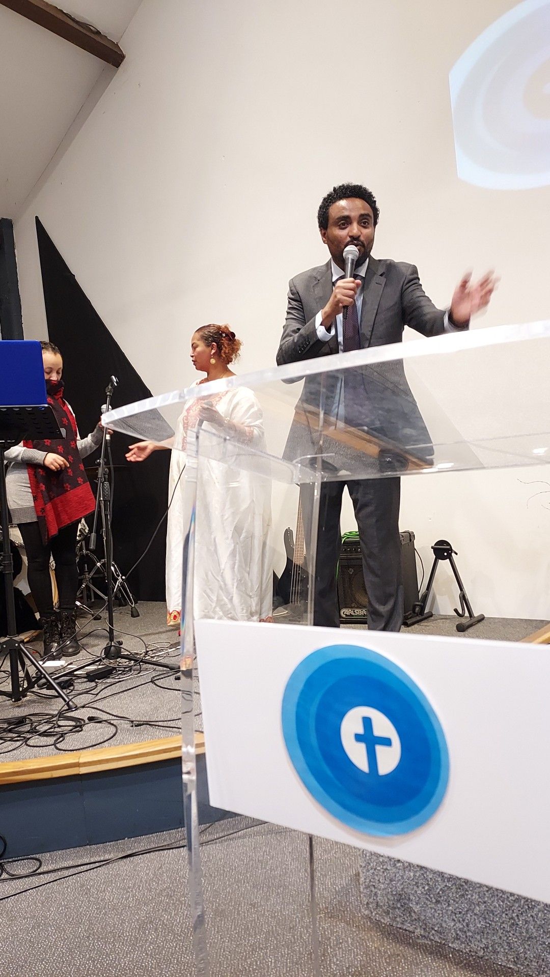 Pastor preaching at The Well Church podium